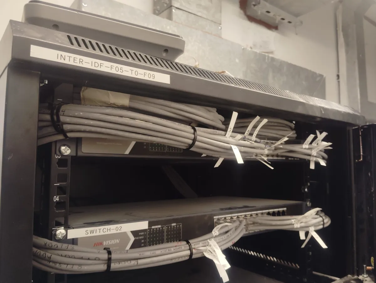 Labelled cable bundles dressed into a rack at R02 Tower